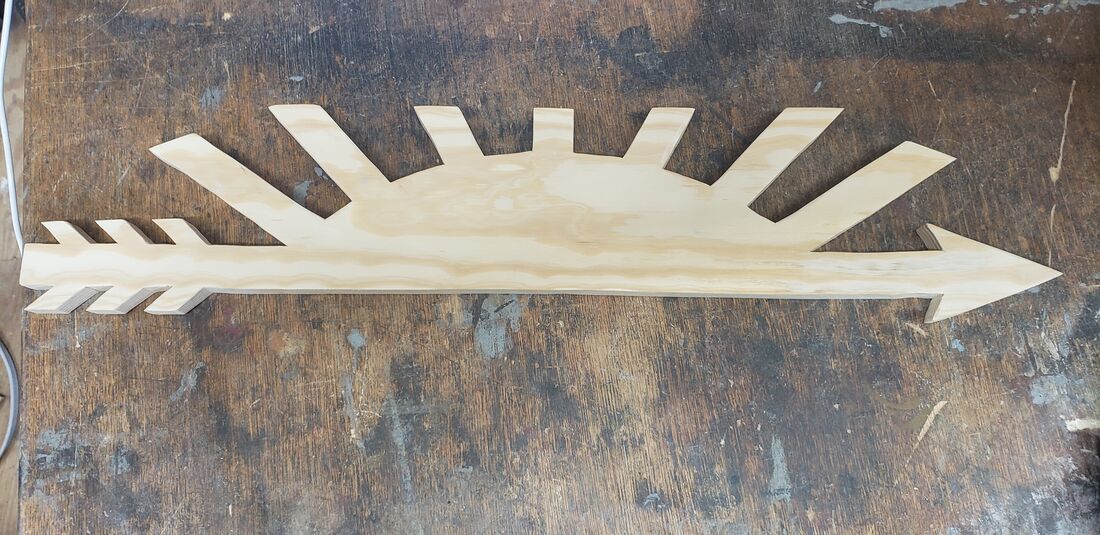 Cub Scout Arrow of Light: an arrow under a rising sun