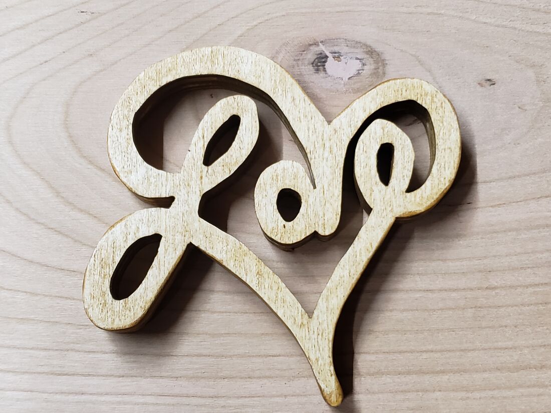 Freestanding script Love inside a heart, cut from light wood