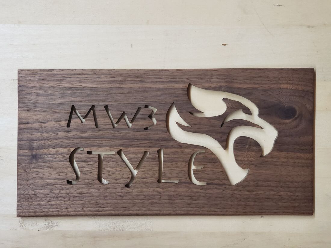 Dark wood sign cut out with MW3 Style and an eagle head